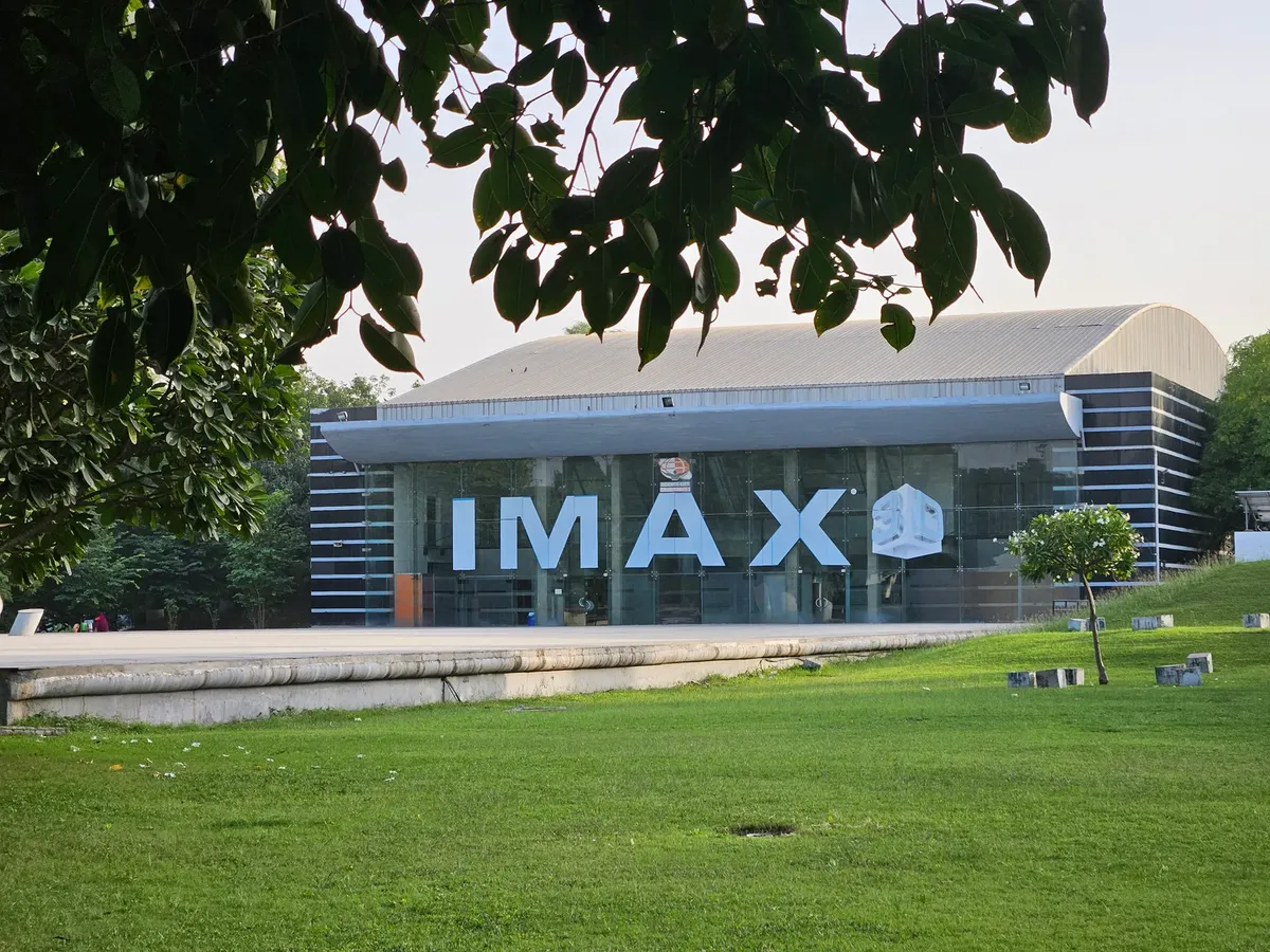 Explore the iconic IMAX theater amidst lush greenery in Ahmedabad, India.