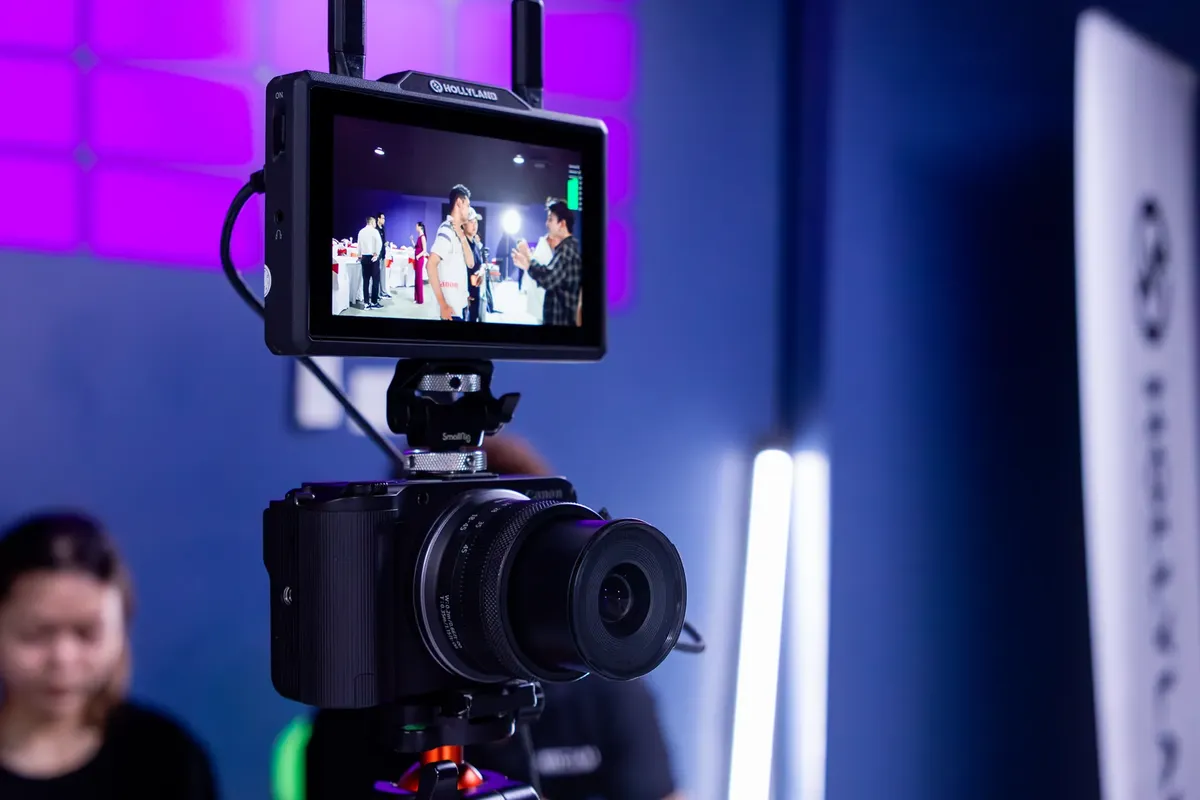 Close-up of a professional video camera with monitor in a studio environment.