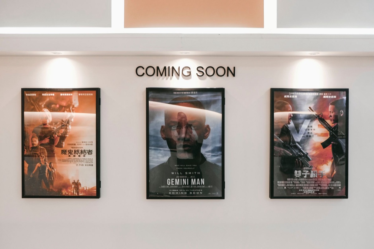 A collection of vibrant Korean movie posters displayed on a wall.