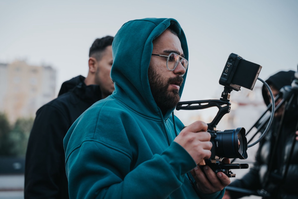 Film director with notebook and camera in a professional setting
