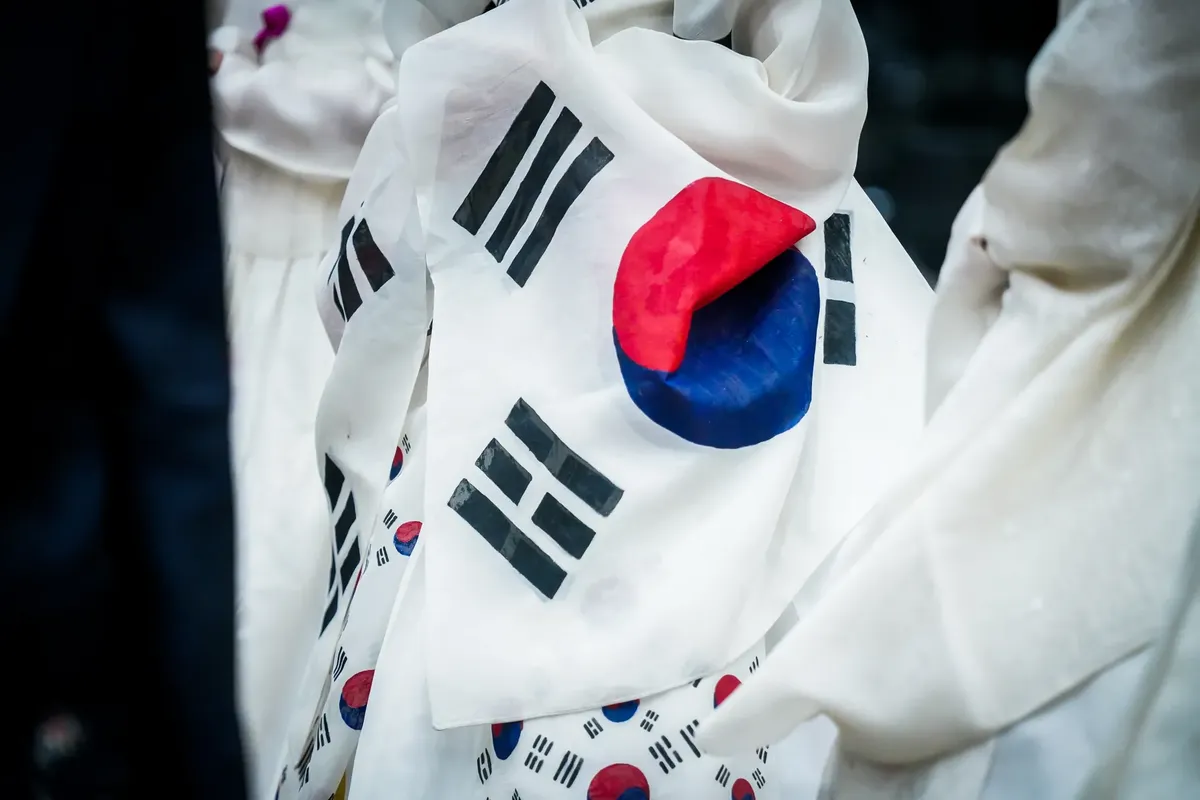 A detailed close-up of the wrinkled South Korean flag on fabric, showcasing its vibrant colors.