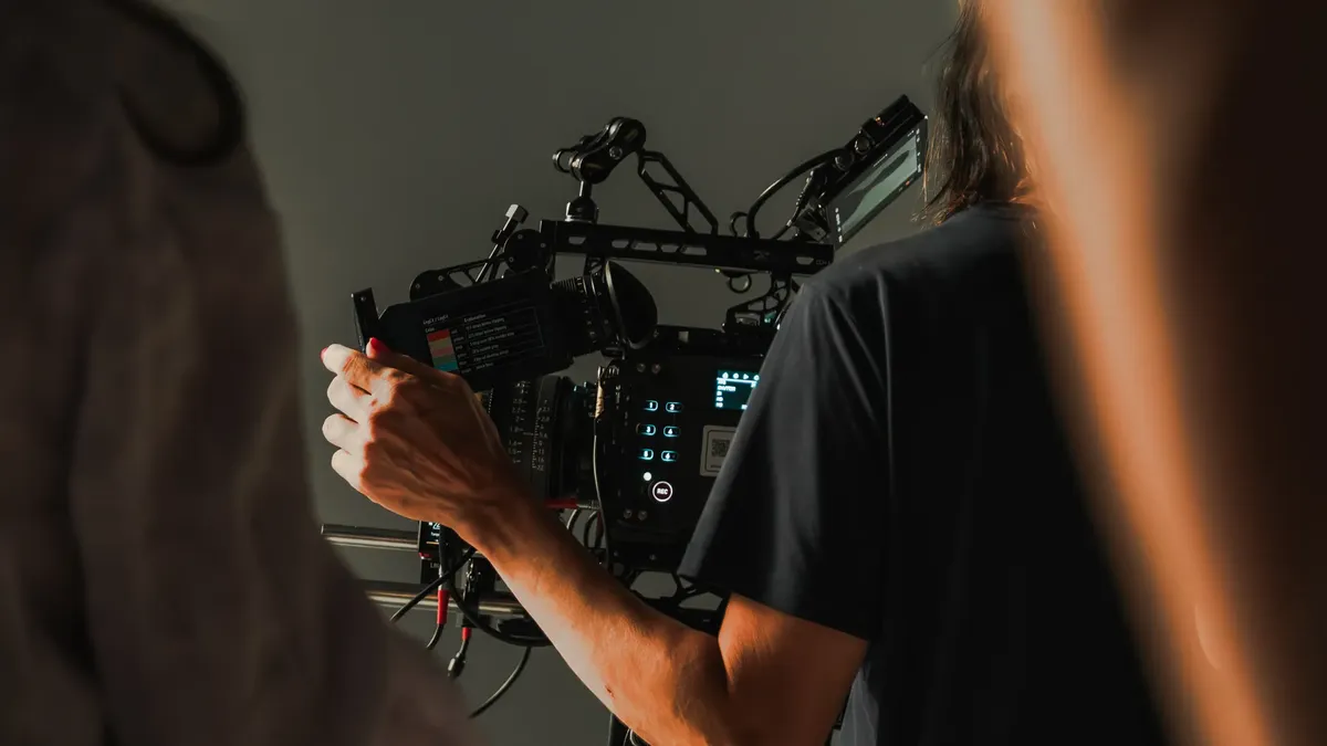 Behind the scenes view of a film crew using professional cinema equipment during a shoot.