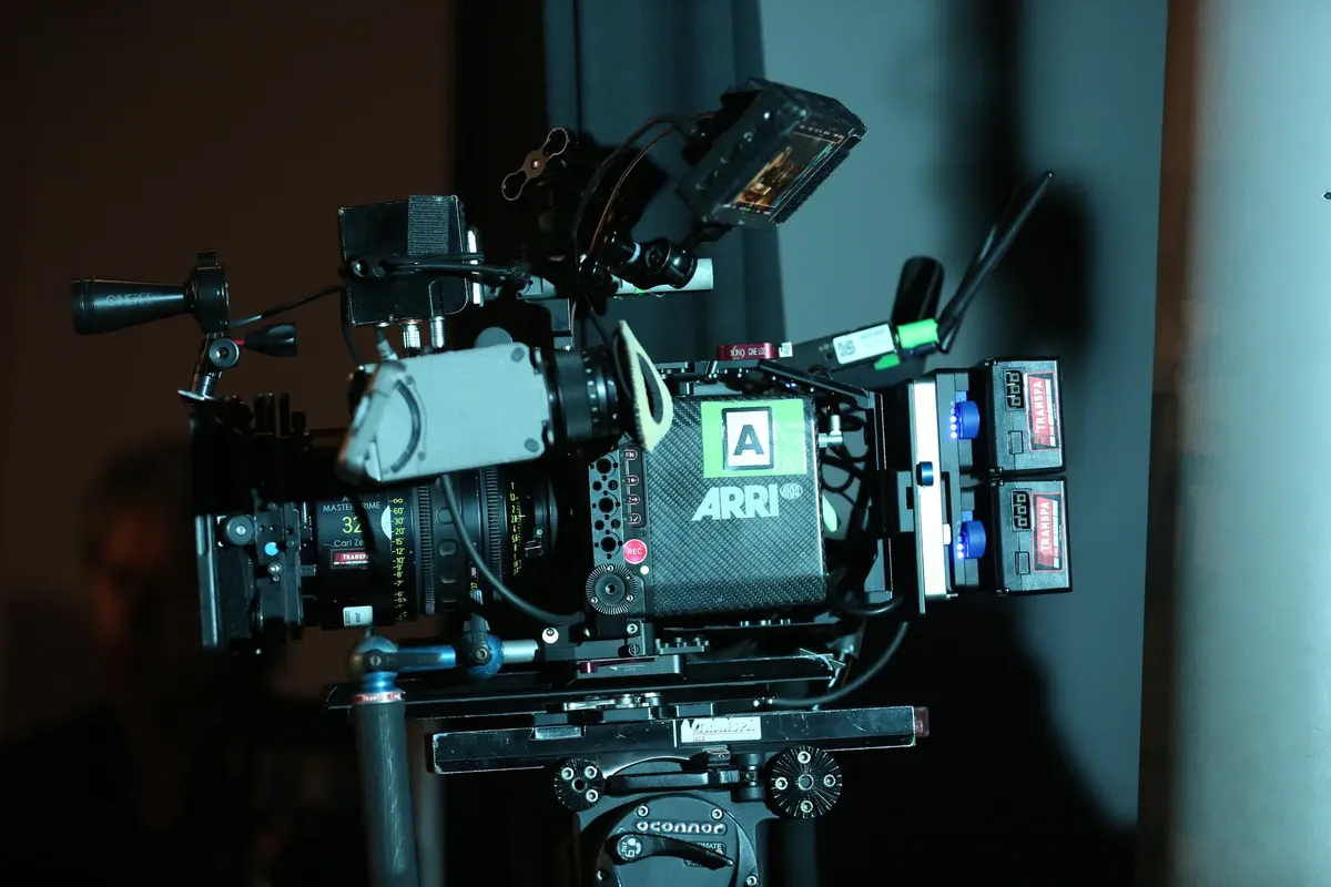 Close-up of a professional ARRI video camera rig set up for filming indoors.