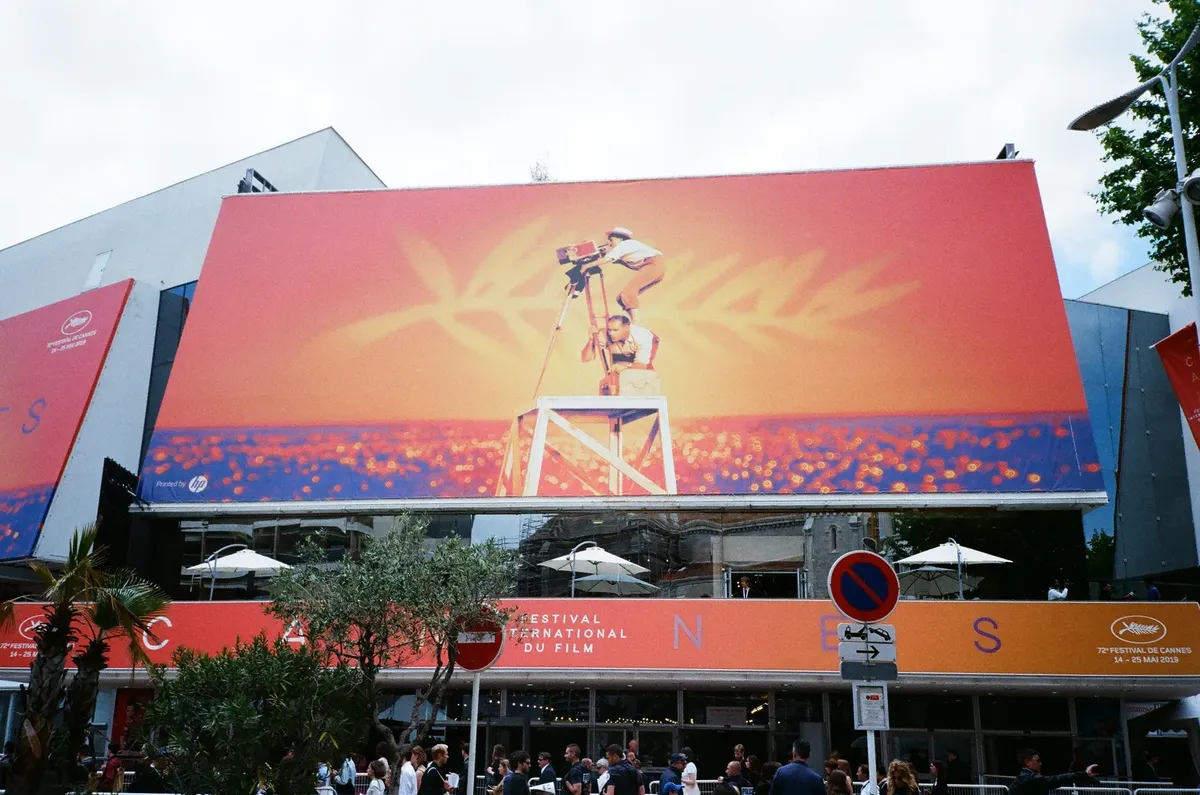 Large billboard at the Cannes Film Festival showcasing vibrant imagery.