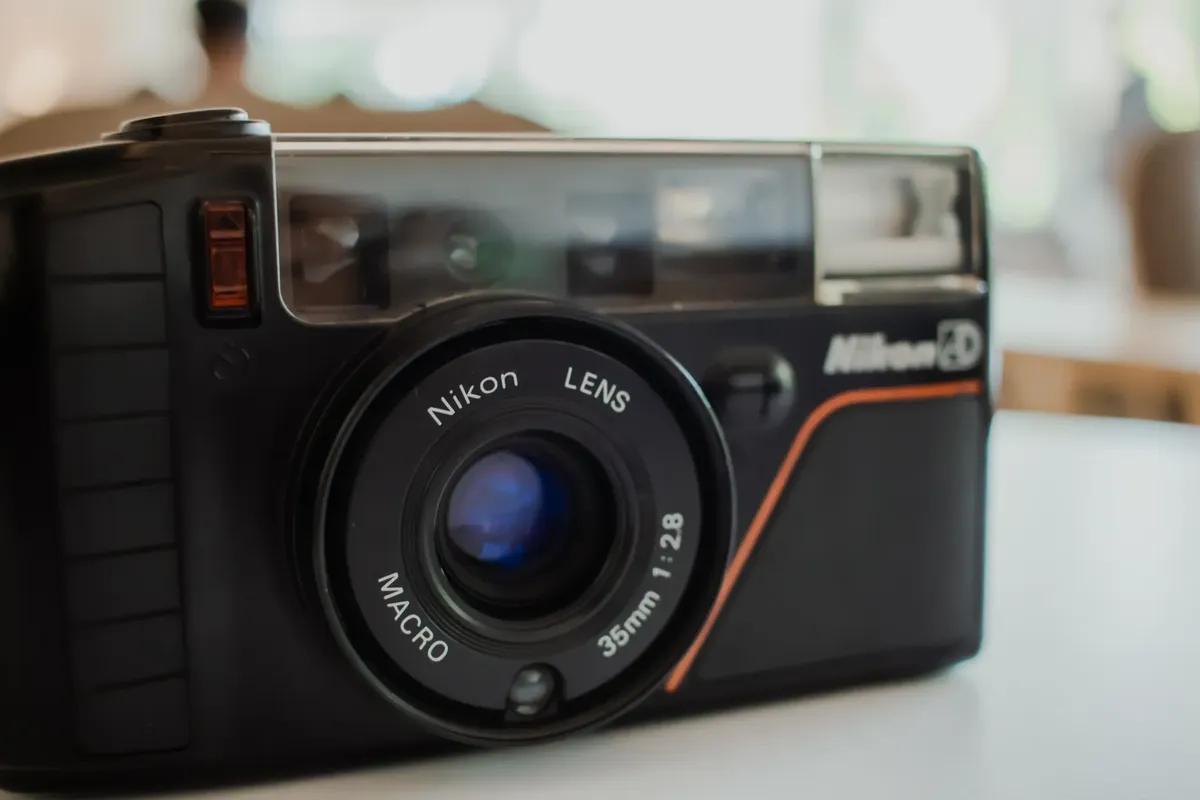 Detailed close-up of a vintage Nikon 35mm film camera with macro lens.