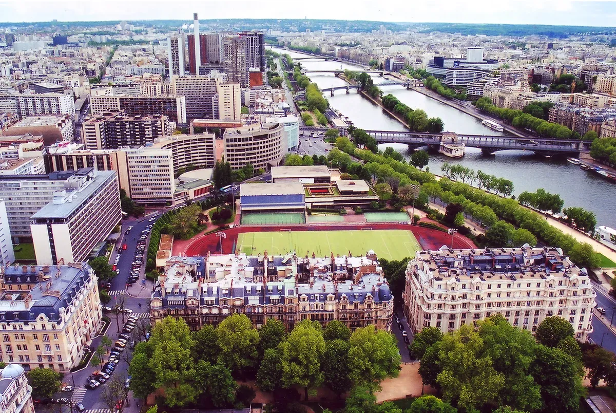 Explore a stunning aerial view of Paris, showcasing the Seine River and urban landscape.