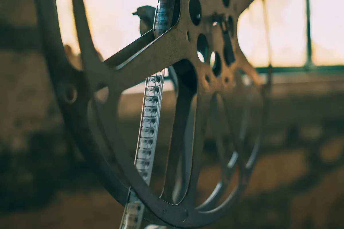 Artistic shot of a vintage film reel with soft light creating a nostalgic atmosphere.