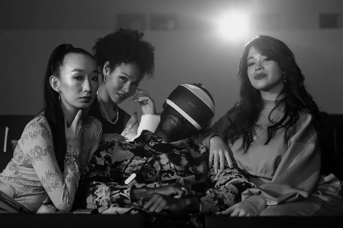 A diverse group of friends experiencing virtual reality in a movie theater setting. Black and white aesthetics.