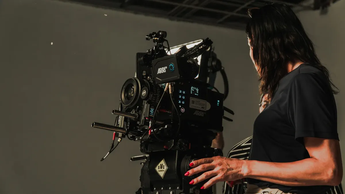 Close-up of a film crew operating a camera rig in a studio, capturing a cinematic production.