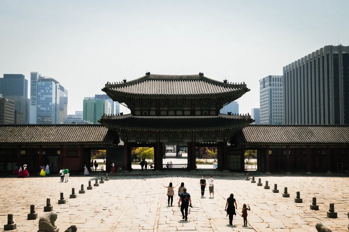 Explore the contrast of ancient Korean architecture with modern skyscrapers in Seoul.