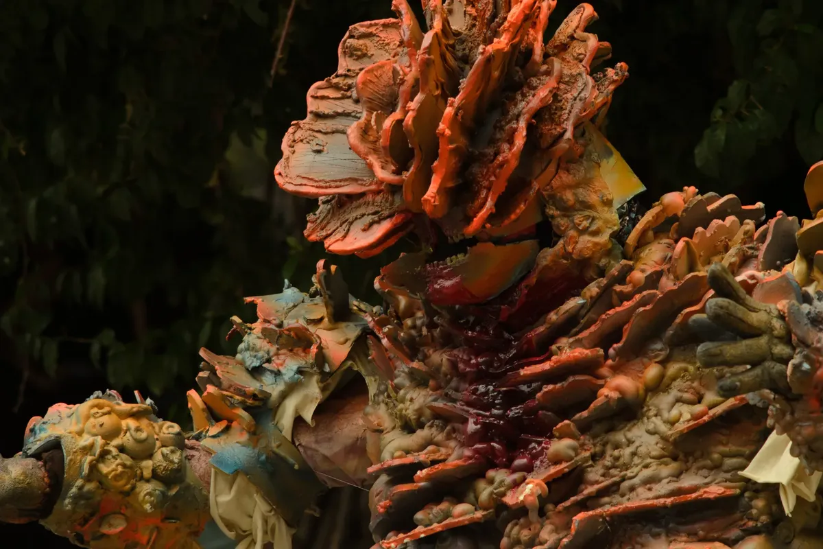 Detailed close-up of an artistic cosplay featuring organic, coral-like textures with vibrant colors.