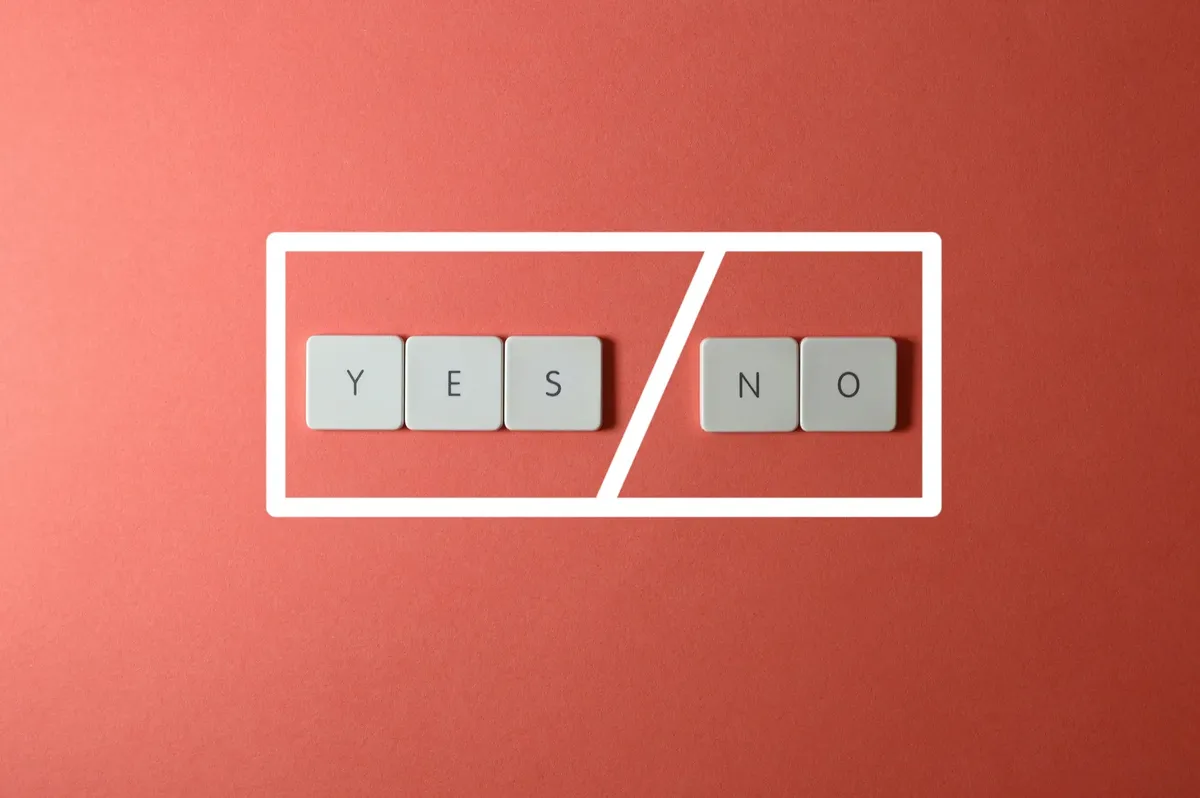 Creative concept of decision making with YES and NO keys on a red background.